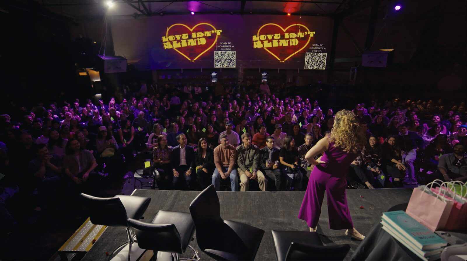 Alli in front of a room packed to the back wall